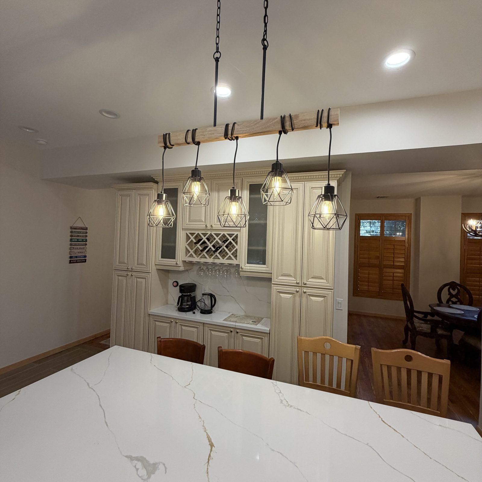 Five-pendant farmhouse island lighting installed over a kitchen island